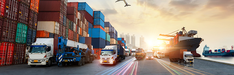 Plane flies over container port with ships and trucks